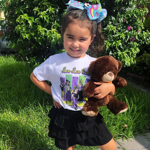 Young Lou Lou Doll wearing the Kids Lou Lou Dolls Tee featuring artwork inspired by the diverse Lil' Lou Lou community.