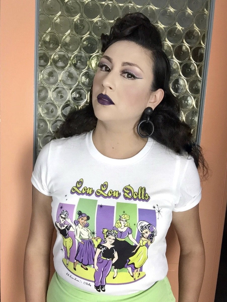 Woman wearing Lil' Lou Lou's Lou Lou Dolls graphic t-shirt featuring vintage-inspired artwork celebrating the creativity and individuality of the Lil' Lou Lou community.