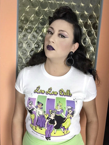 Woman wearing Lil' Lou Lou's Lou Lou Dolls graphic t-shirt featuring vintage-inspired artwork celebrating the creativity and individuality of the Lil' Lou Lou community.