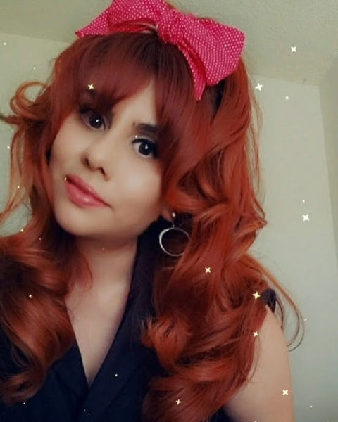 Customer styling Lil' Lou Lou Minnie Bow hair clip in red mini dot cotton fabric with vintage inspired Brigitte Bardot style hairstyle