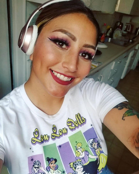 Orange Dolly Cartoons artist Nina wearing the Lou Lou Dolls graphic t-shirt inspired by the diverse women of the Lil' Lou Lou community.
