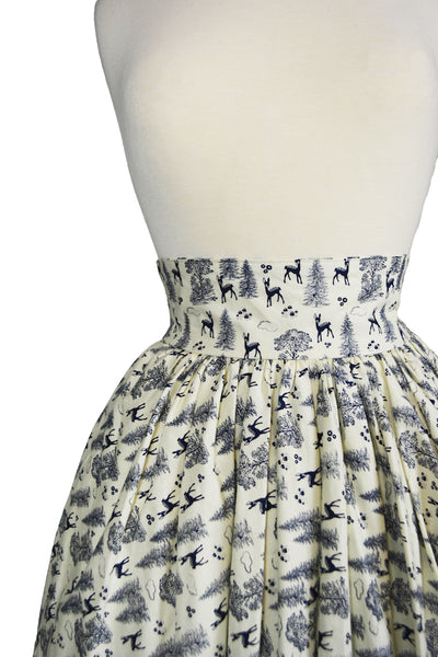 Close-up detail of the Ella Mae Skirt featuring the Queen of the Forest deer and woodland print, wide waistband, and gathered vintage-inspired silhouette.