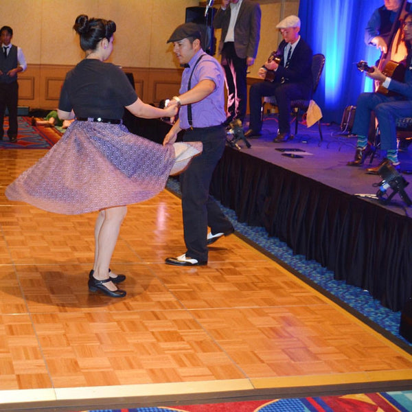 Customer dancing in the Haunting Wallpaper Jivin' Skirt by Lil' Lou Lou, showcasing the full gathered silhouette and twirl-friendly design at a vintage dance event.
