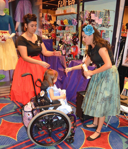 Lil' Lou Lou designer wearing the Morticia's Garden Green Jivin' Skirt while creating a vintage hairstyle for a young Lou Lou Doll at Dapper Day.