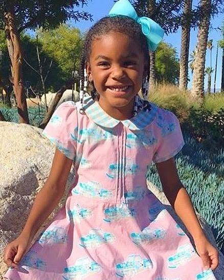 Customer wearing Lil' Lou Lou Melly Dress in pink Classic Truck print with Peter Pan collar and vintage-inspired silhouette outdoors