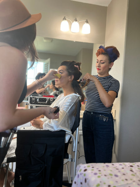 Hairstylist wearing the Lil' Lou Lou navy striped tee while styling hair at a vintage-inspired wedding.
