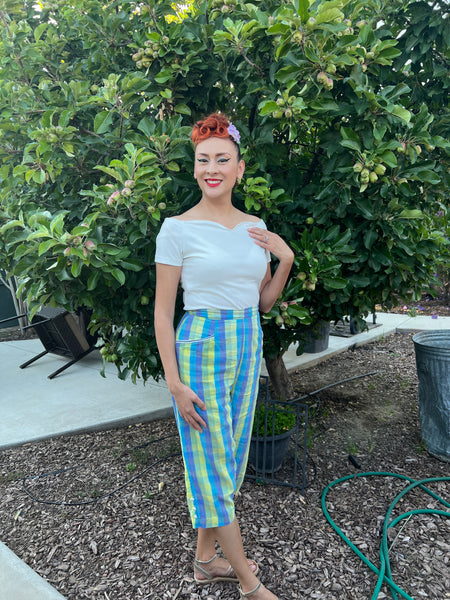 Ivory Rockin' Cori off-the-shoulder top by Lil' Lou Lou styled with a Rosita flower hair accessory and vintage capri pants.