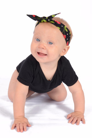 Baby wearing Lil' Lou Lou's Black Cherry Dots 3 in 1 baby headband with removable bow.