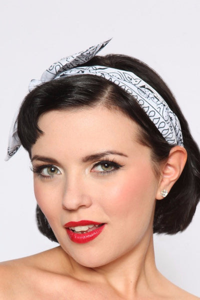Model wearing Lil' Lou Lou's 4 in 1 Classic White Bandana Print Headband styled with the bow worn to the side.