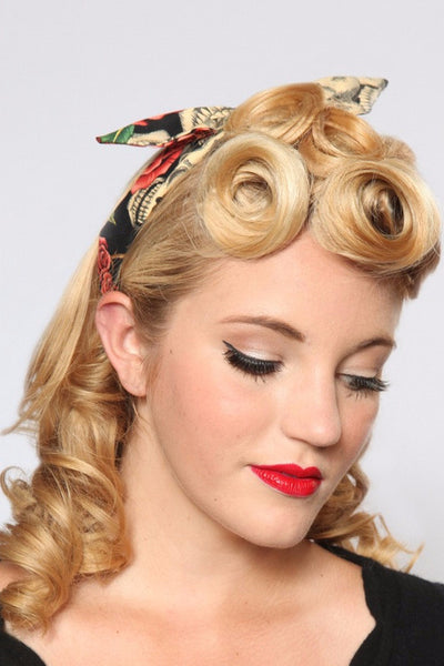 Model wearing Lil' Lou Lou's Peach Skull Roses 4 in 1 Headband featuring a skull and rose print with the bow styled in the center.