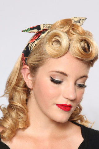 Model wearing Lil' Lou Lou's Peach Skull Roses 4 in 1 Headband featuring a skull and rose print with the bow styled in the center.