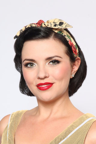 Model wearing Lil' Lou Lou's 4 in 1 Beige Skull Roses Headband with the bow styled in the center, featuring a beige skull and rose print.