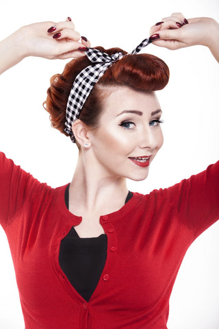 Model wearing Lil' Lou Lou 4 in 1 Black Picnic Headband in black and white gingham with the bow worn centered, demonstrating one of four styling options.