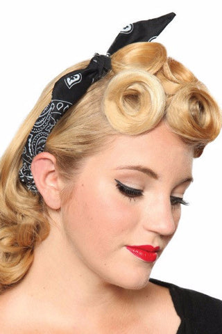 Model wearing the Lil' Lou Lou 4 in 1 Classic Black Headband with white bandana print, styled with vintage pin curls and a centered bow.