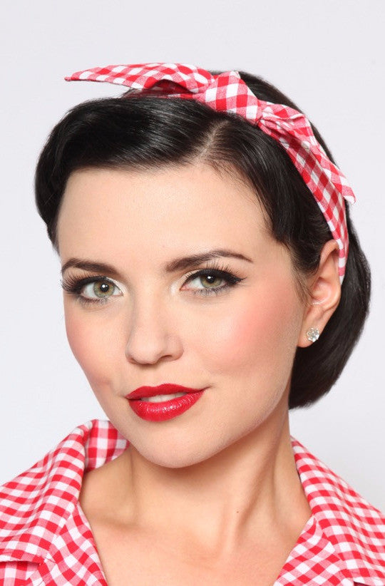 Woman wearing Red Picnic 4 in 1 headband featuring red gingham fabric and bow detail.
