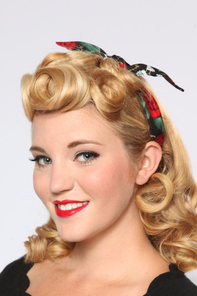 Model wearing Lil' Lou Lou Red Skull Roses 4 in 1 headband with bow positioned near the side part for a vintage-inspired look.