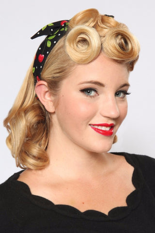 Woman wearing Lil' Lou Lou 4 in 1 Black Cherry Dots Headband styled with a knotted bow and vintage-inspired hairstyle.