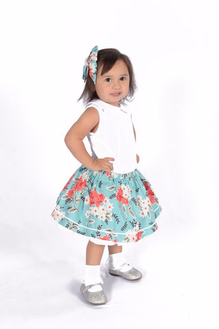 Girl wearing the Flea Market Girly Skirt featuring a vintage floral print, elastic waistband and signature ric rac trim by Lil' Lou Lou.