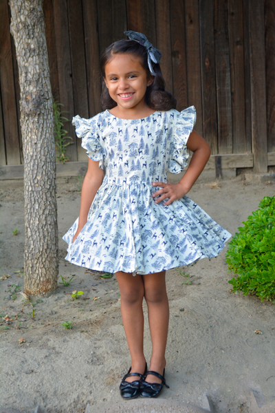Gianna Dress in the Queen of the Forest woodland print showing the adjustable waist ties worn tied in the back for an alternate fit and styling option.