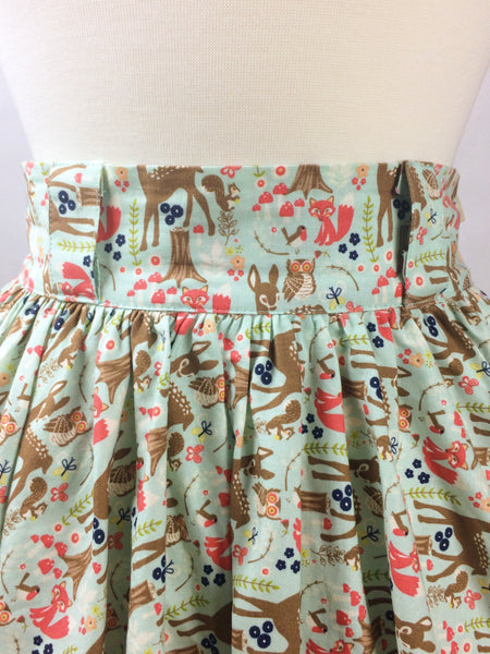 Close-up of the Lil' Lou Lou Jivin' Skirt in the Princess of the Forest woodland print featuring deer, foxes, owls, and forest animals.