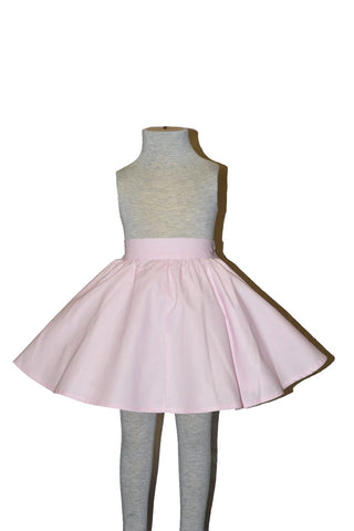 Vintage inspired pink girls circle skirt by Lil' Lou Lou with elastic waistband displayed on mannequin.