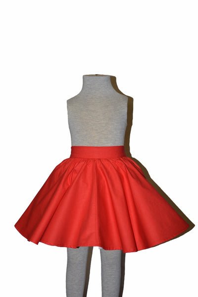 Red cotton Kids Jivin' Skirt by Lil' Lou Lou displayed on mannequin with full circle skirt silhouette and elasticized back waistband.