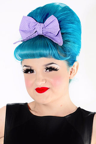 Model wearing Lil' Lou Lou Minnie Bow hair clip in lilac mini dot cotton fabric styled with a vintage inspired beehive hairstyle