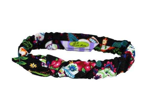 Colorful Skulls Mommy & Me Headband featuring a soft elastic band and knotted bow detail for babies and toddlers.
