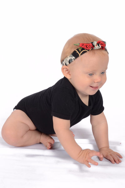 Baby wearing Lil' Lou Lou red skull and rose Mommy & Me Headband with a vintage-inspired bow detail.