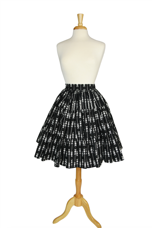 Vintage-inspired Boogie Woogie Skirt in Lil' Lou Lou's Arrows print, a high-waisted tiered black and white cotton skirt displayed on a dress form.