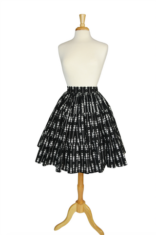 Vintage-inspired Boogie Woogie Skirt in Lil' Lou Lou's Arrows print, a high-waisted tiered black and white cotton skirt displayed on a dress form.