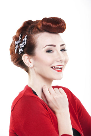 Model wearing Black Picnic Cute Knotted Bow by Lil' Lou Lou styled with bumper bangs and a vintage-inspired updo.