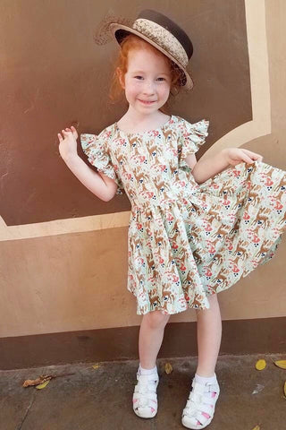 Young girl wearing the Gianna Dress in the Princess of the Forest woodland print styled for Dapper Day.