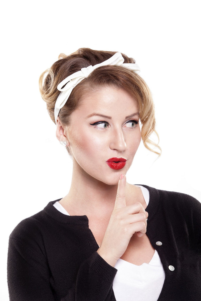 Model wearing the Jackie Headband in ivory velvet elastic with a 1960s-inspired bow detail, perfect for vintage-inspired bridal style.