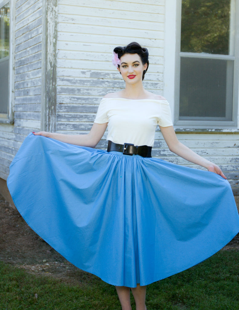Model wearing the blue Jivin' Skirt styled with the Rockin' Cori Top and Lil' Lou Lou Camelia Flower, showcasing the skirt's full gathered silhouette.