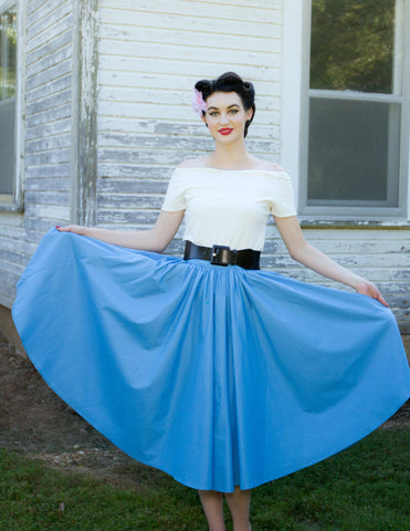 Model wearing the blue Jivin' Skirt styled with the Rockin' Cori Top and Lil' Lou Lou Camelia Flower, showcasing the skirt's full gathered silhouette.