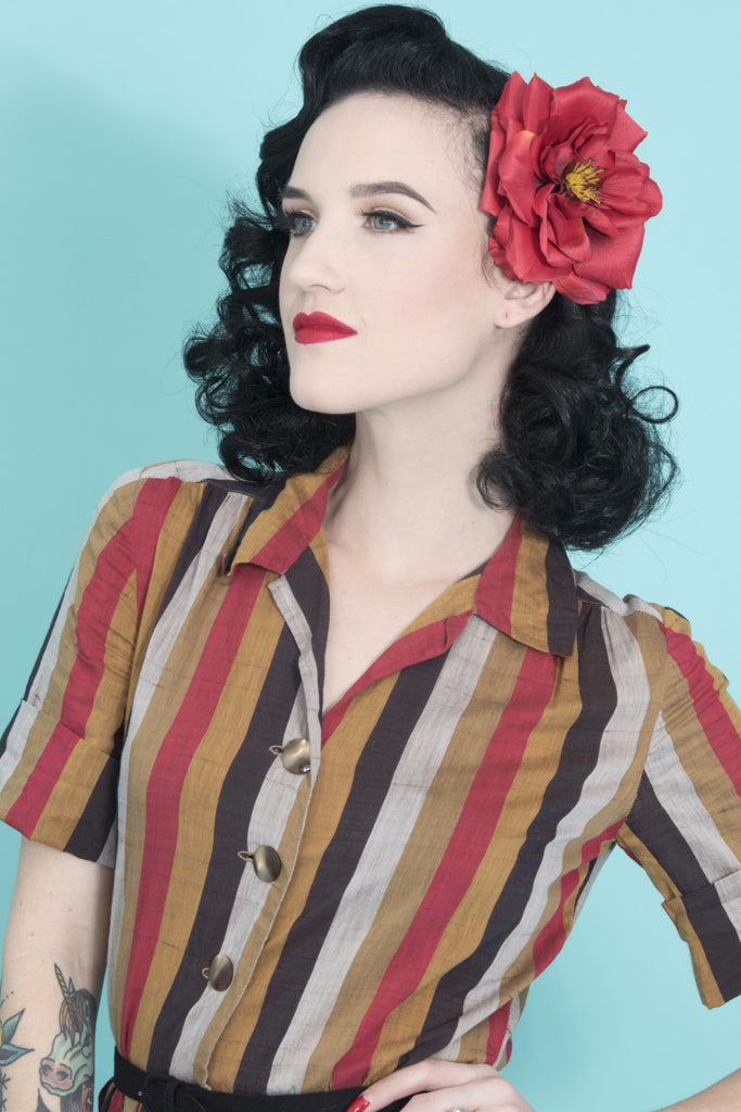 Model wearing the April Moon Rose Red Hair Flower styled with a vintage-inspired Pin Up hairstyle.