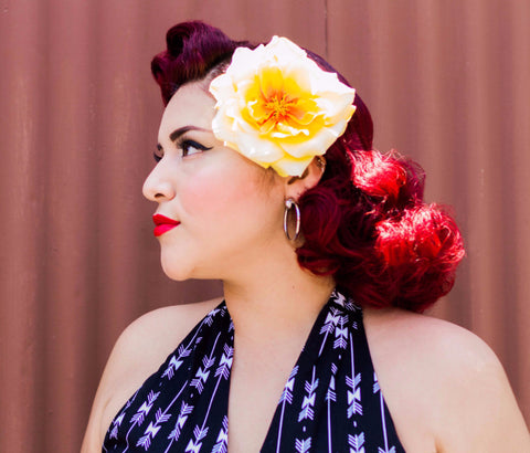 Model wearing the April Moon Rose Yellow Hair Flower styled in a vintage-inspired hairstyle. Hair styling by Lil' Lou Lou.