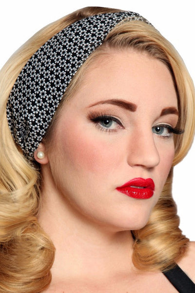 Model wearing a black and white daisy print Bombshell Hair Wrap styled with vintage-inspired curls.