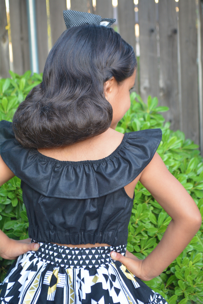 Back view of girl's black Cha Cha ruffle crop top with elastic back waistband