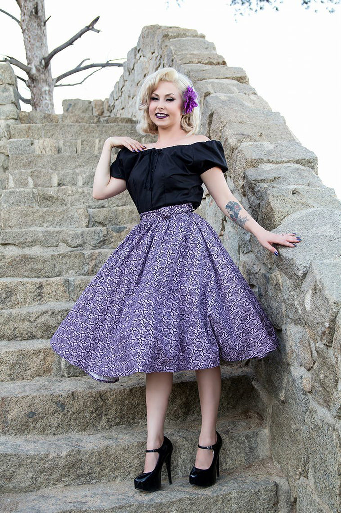 Model wearing a black Mary Blouse by Lil' Lou Lou with the purple Haunting Wallpaper Jivin' Skirt, showcasing vintage-inspired off-the-shoulder styling.