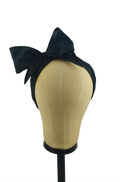 Black Minnie Headband with oversized bow displayed on a mannequin head, vintage-inspired cotton hair scarf headband by Lil' Lou Lou.