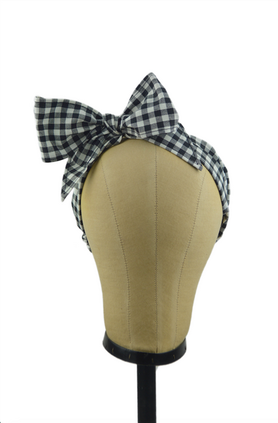 Black gingham Minnie Headband with oversized bow displayed on a mannequin head, vintage-inspired cotton hair scarf headband by Lil' Lou Lou.