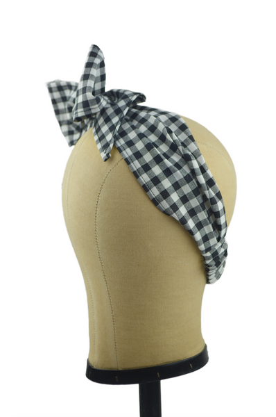 Black gingham Minnie Headband with oversized side bow displayed on a mannequin head, vintage-inspired cotton hair scarf headband by Lil' Lou Lou.