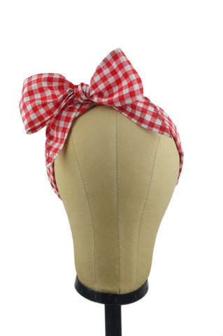 Red gingham Minnie Headband with oversized bow displayed on a mannequin head, vintage-inspired cotton hair scarf headband by Lil' Lou Lou.