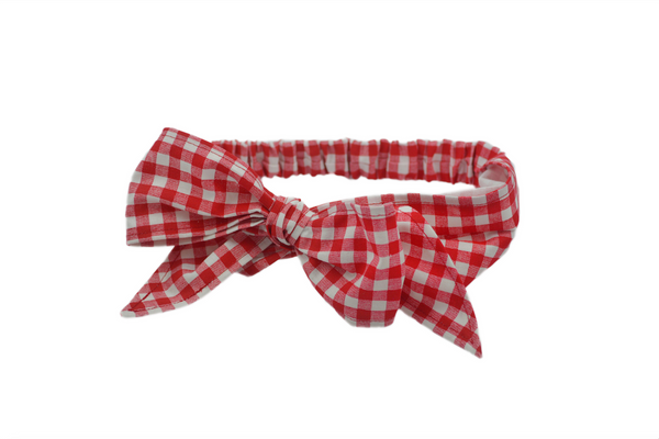 Red gingham Minnie Headband with oversized bow shown in flat lay view, vintage-inspired cotton hair scarf headband by Lil' Lou Lou.