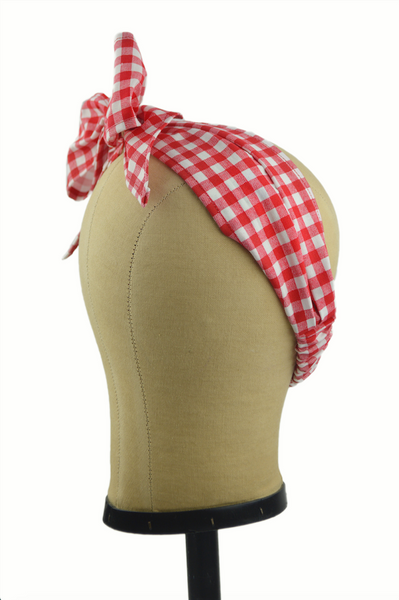 Side view of a red gingham Minnie Headband with oversized bow displayed on a mannequin head, vintage-inspired cotton hair scarf headband by Lil' Lou Lou.