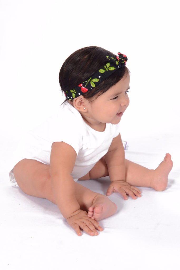 Baby wearing Black Cherry Dots Mommy & Me Headband featuring cherry print and soft elastic fit