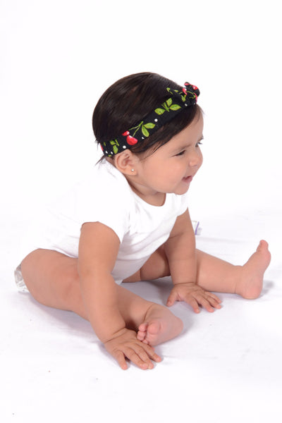 Baby wearing Black Cherry Dots Mommy & Me Headband featuring cherry print and soft elastic fit