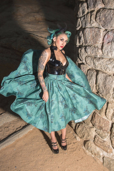 Model wearing the Morticia's Garden Green Jivin' Skirt by Lil' Lou Lou, a vintage-inspired full circle skirt with gothic floral print.